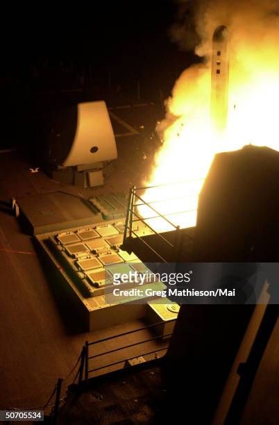 Tomahawk land attack missile being launched from aboard the guided missile destroyer USS John Paul Jones in a strike against al Qaeda terrorist...