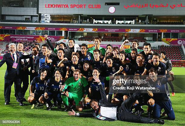 Makoto Teguramori Head coach of Japan and his team members and staffs pose for photographs after qualifying for the Rio de Janeiro Olympics by...