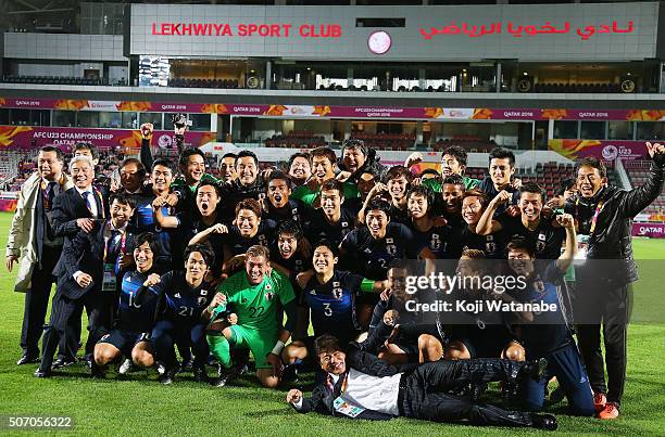 Makoto Teguramori Head coach of Japan and his team members and staffs pose for photographs after qualifying for the Rio de Janeiro Olympics by...