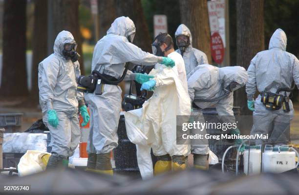 Marines with the Chemical Biological Incident Responce Force working in hazmat gear as they decontaminate the Longworth House Office building of...