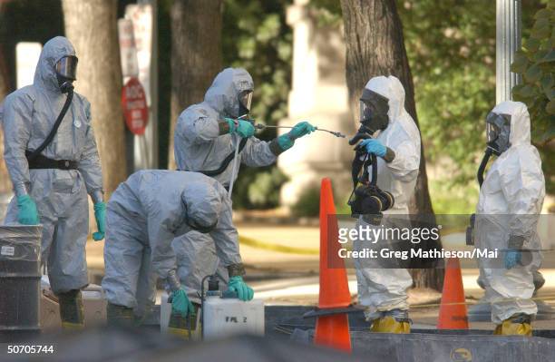 Marines with the Chemical Biological Incident Responce Force working in hazmat gear as they decontaminate the Longworth House Office building of...