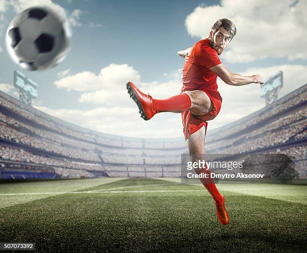 soccer player kicking ball in stadium - shootout stock pictures, royalty-free photos & images