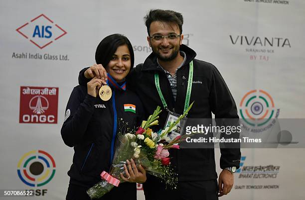 Pistol Shooter Heena Sidhu with her husband Ronak Pandit after winning gold in 10 metre air pistol in Asian Olympic Qualifying Competition at Dr....