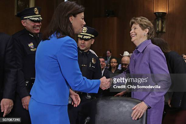 New Hampshire senators Kelly Ayotte and Jeanne Shaheen greet one another before a Judiciary Committee hearing about the impact of a spike in heroin...
