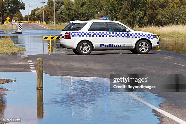 police roadblock protects flooding road - police car stock pictures, royalty-free photos & images