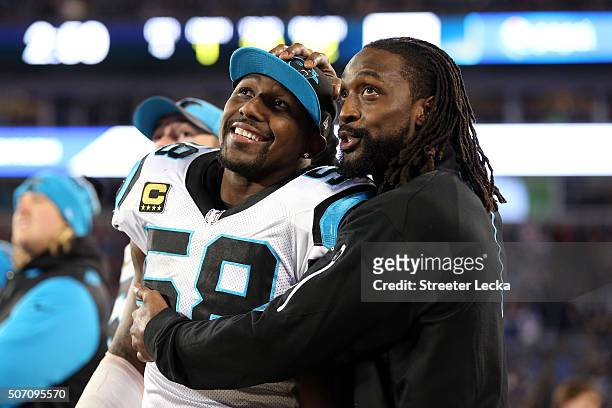 Thomas Davis and Charles Tillman of the Carolina Panthers look on from the sidelines during the NFC Championship Game against the Arizona Cardinals...