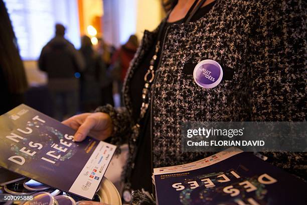 Woman distributes leaflets on January 27, 2016 during La Nuit des Idees held at the French Ministry of Foreign Affairs also know as the Quai d'Orsay...