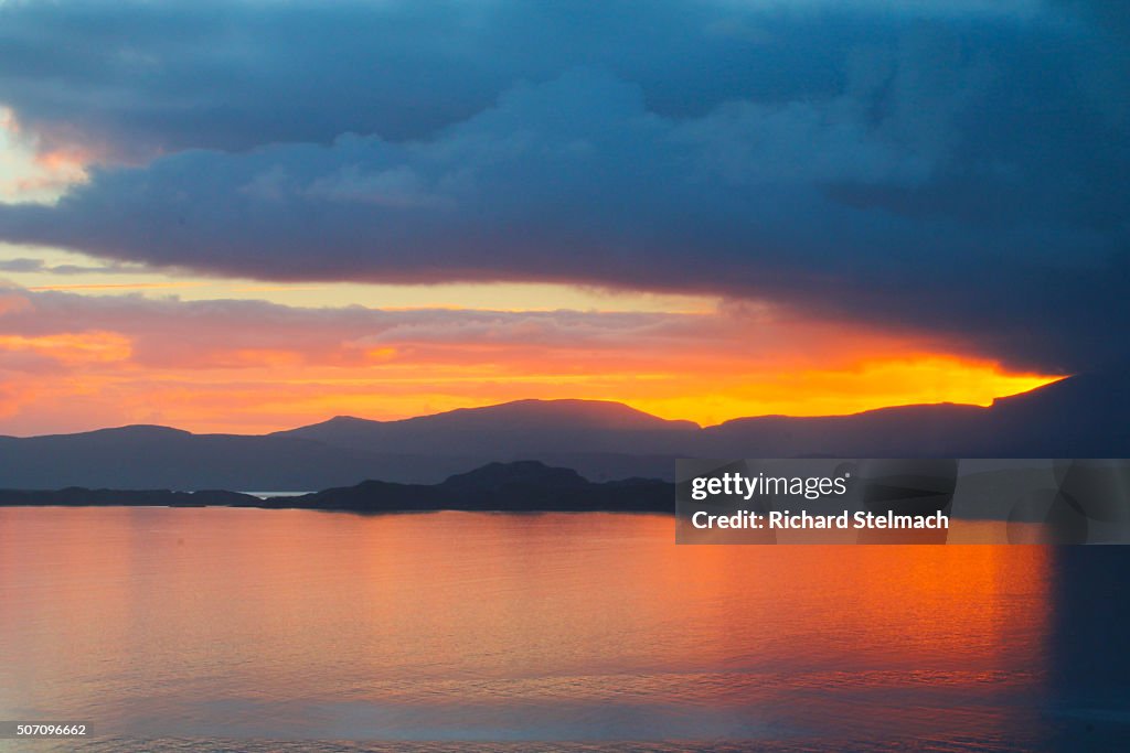 Red sunset over loch, taken from mainland Wester Ross, overlooking Raasay and Skye