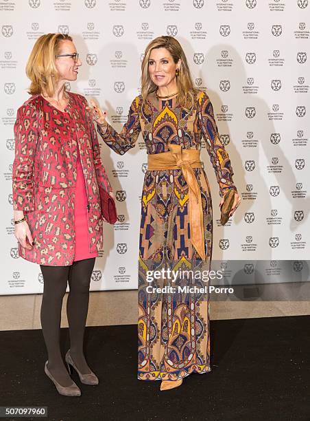 Queen Maxima of The Netherlands , wearing an Etro jumpsuit, and Janneke Staarink attend the opening of the Rotterdam International Film Festival on...