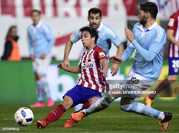 Atletico Madrid's midfielder Oliver Torres vies with Celta Vigo's defender Sergi Gomez during the Spanish Copa del Rey quarterfinal second leg...
