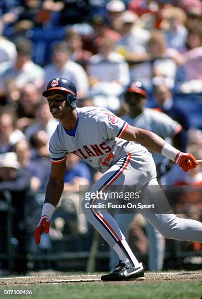 Julio Franco of the Cleveland Indians swings and watches the flight of his ball against the Baltimore Orioles during a Major League Baseball game...