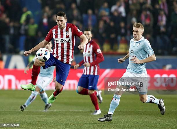 Koke of Atletico Madrid vies with Daniel Wass of Celta Vigo during the Copa del Rey Quarter Final 2nd Leg match between Club Atletico de Madrid and...