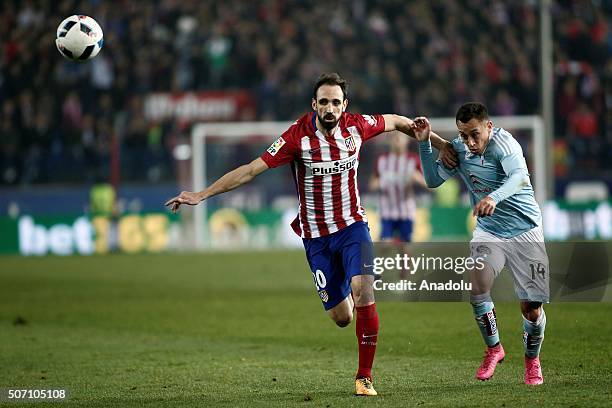 Juanfran of Atletico Madrid vies with Fabian Orellana of Celta Vigo during the Copa del Rey Quarter Final 2nd Leg match between Club Atletico de...