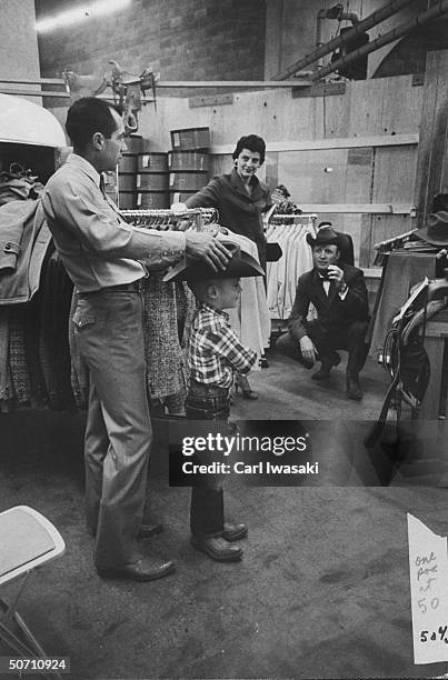 Ranch family shopping for a 5-gallon hat for their 4 year old son during the stock show.