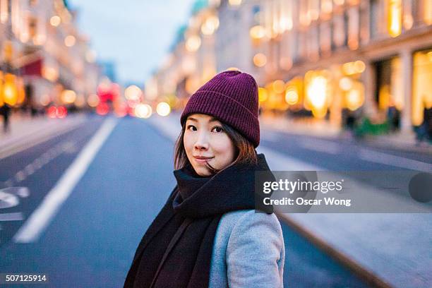 Young Asian smiling at camera in city