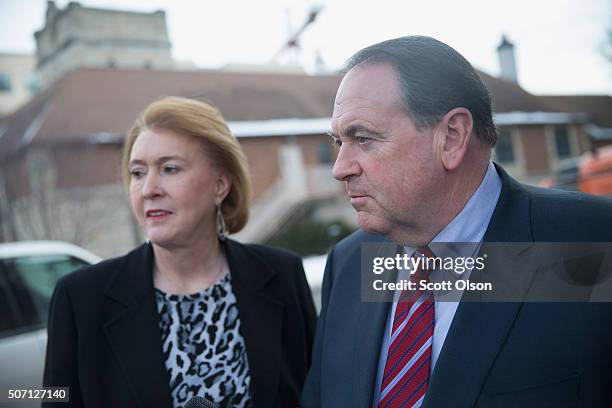 Republican presidential candidate Mike Huckabee is greeted by his wife Janet as he arrives for a campaign stop at Jeff's Pizza on January 27, 2016 in...