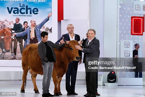 Actors Jamel Debbouze, Lambert Wilson, Fatsah Bouyahmed, Presenter of the show Michel Drucker and a cow present the Movie 'La Vache' during the...