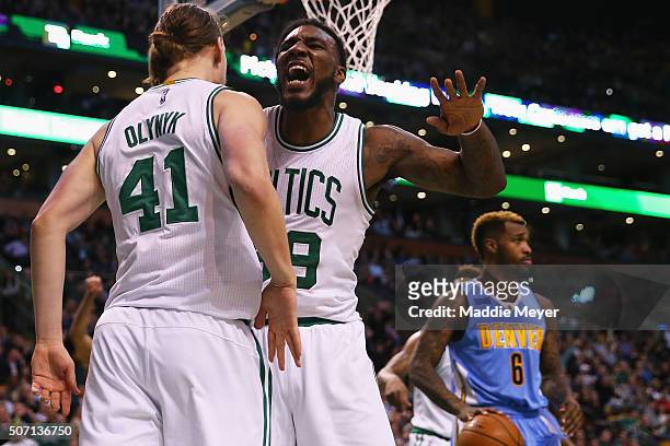 Jae Crowder of the Boston Celtics congratulates Kelly Olynyk after he scored against the Denver Nuggets during the third quarter at TD Garden on...