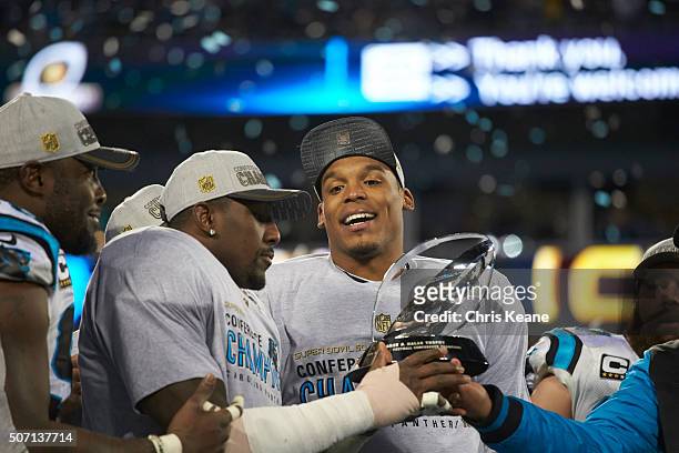 Playoffs: Carolina Panthers QB Cam Newton victorious on field with George Halas Trophy after winning game vs Arizona Cardinals at Bank of America...