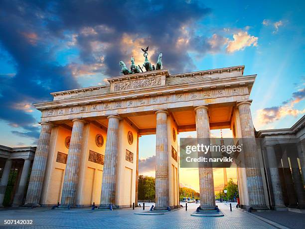 brandenburg gate and the tv tower in berlin - germany famous landmarks stock pictures, royalty-free photos & images
