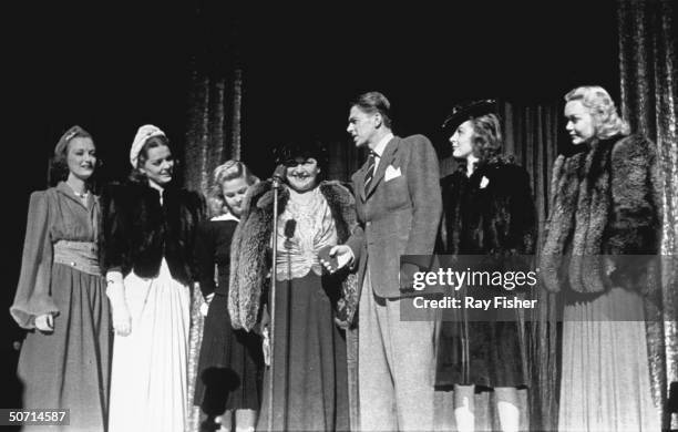 Actresses Arleen Whelan, Joy Hodges, June Preisser, columnist Louella Parsons, actor Ronald Reagan, actresses Susan Hayward and Jane Wyman on stage...