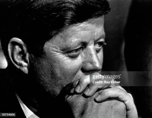 Pensive closeup of US President John F. Kennedy during a banquet.