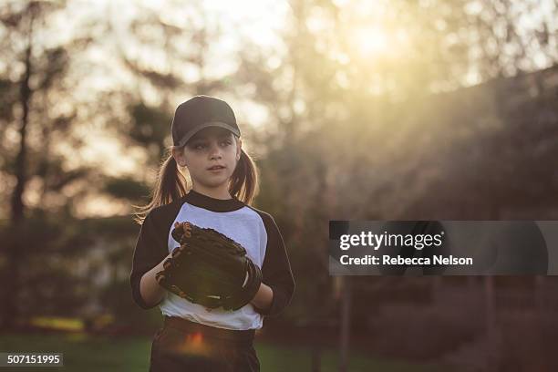 girl getting ready to throw baseball - kid baseball pitcher stock pictures, royalty-free photos & images