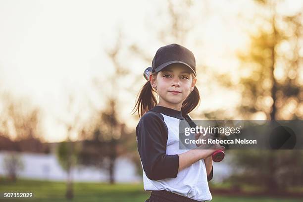 girl holding baseball bat - baseball kid stock-fotos und bilder