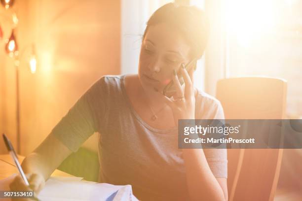 young woman trying to pay her bills - bailiff stock pictures, royalty-free photos & images