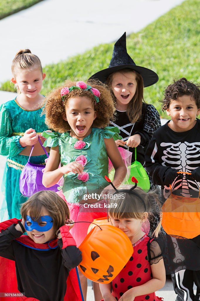 Multi-racial group of children in halloween costumes