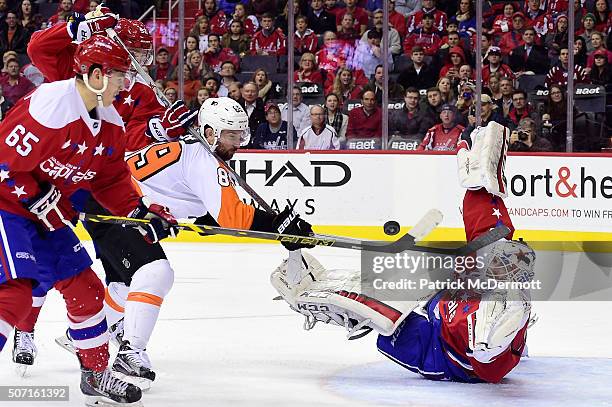 Braden Holtby of the Washington Capitals makes a save against Sam Gagner of the Philadelphia Flyers in the second period during their game at Verizon...