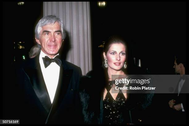American businessman and automobile executive John DeLorean and his third wife, model and actress Cristina Ferrare arrive at the opening of the...