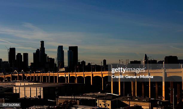 The Sixth Street Bridge, a 3,500-foot concrete span that connects the downtown Arts District to Boyle Heights, glows like a beacon on the last day it...