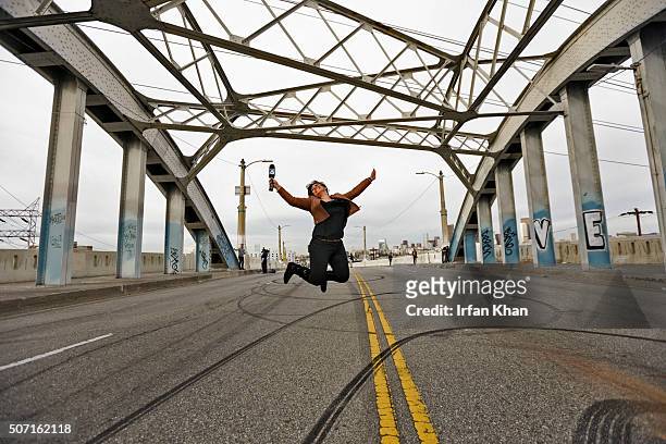 Lynette Romero, an anchor/reporter KTLA, jumps in air for a photo on Sixth Street Bridge which is set for demolition.