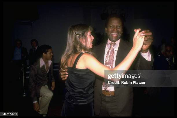 Actor Sidney Poitier dancing with wife Joanna Shimkus at Studio 54.