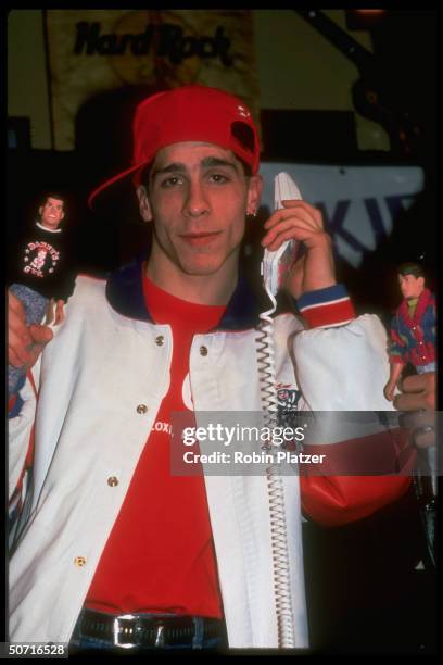 Member of pop group New Kids on the Block, Danny Wood holding toy doll of himself.