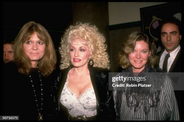 Singer Dolly Parton flanked by Gloria Steinem and Jane Curtin .