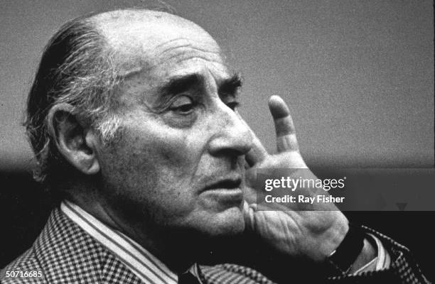 Famous photographer Alfred Eisenstaedt listening, holding his hand to his ear, during a conference.