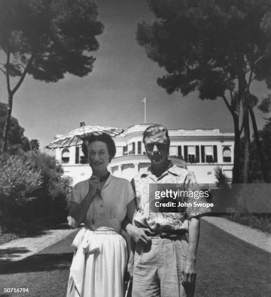 The Duke and Duchess of Windsor on the Riviera; the Duchess is using a parasol to shield her from the sun.