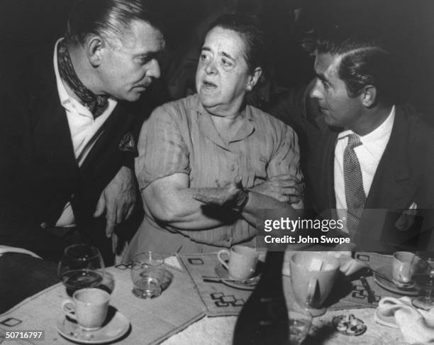 Clark Gable and Tyrone Power with Elsa Maxwell during party on the Riviera.