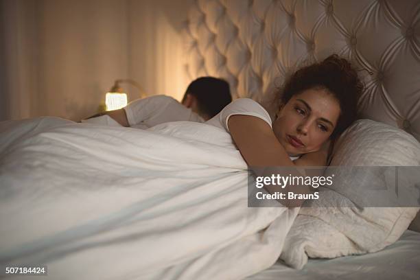 sad woman having problems in bed with her boyfriend. - vidbild bildbanksfoton och bilder