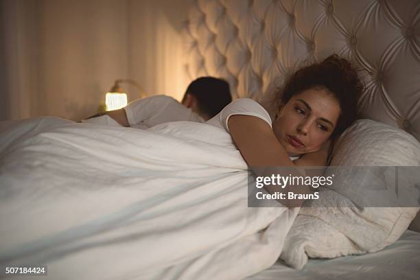 sad woman having problems in bed with her boyfriend. - avlägsen bildbanksfoton och bilder