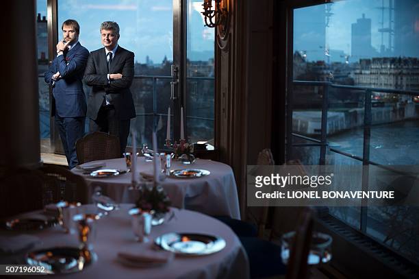 Director of La tour d'Argent restaurant Andre Terrail and Artcurial auctioneer Francois Tajean pose at the restaurant in Paris on January 26, 2016....