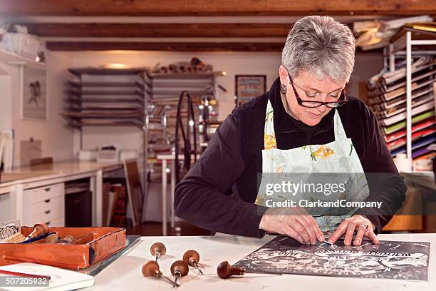 portrait of a printmaker artist at work - linocut stock pictures, royalty-free photos & images