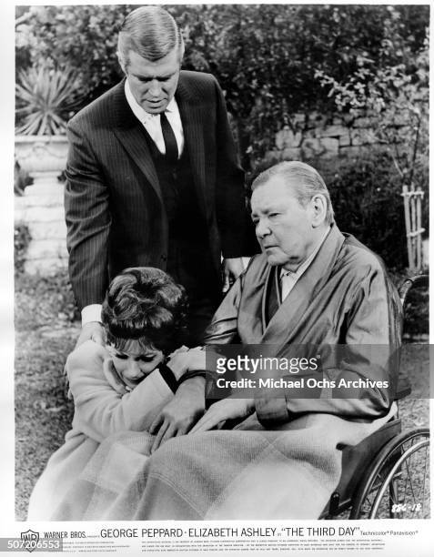 Elizabeth Ashley weeps as she realizes Herbert Marshall is helpless as George Peppard consoles her in a scene from the Warner Bros. Movie "The Third...