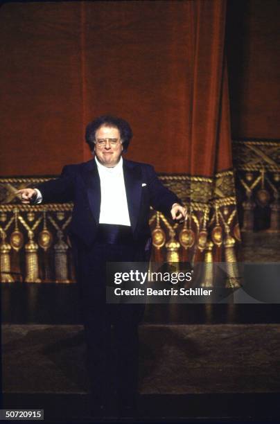 Music dir. & conductor James Levine pointing down at the orchestra as he takes a curtain call after a performance of Verdi's I Lombardi on stage at...