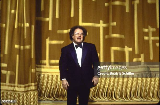 Music dir. & conductor James Levine basking in applause as he takes a curtain call after a performance on stage at the Metropolitan Opera.