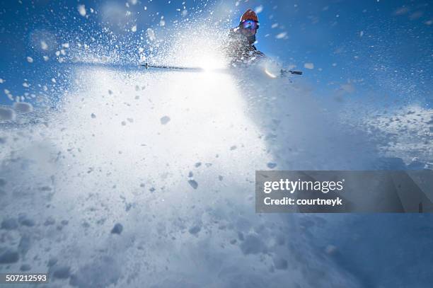 skier turning in a spray of snow - ski new zealand stock pictures, royalty-free photos & images