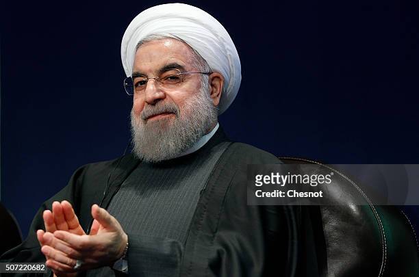 Iranian President Hassan Rouhani attends a meeting with the French Prime Minister Manuel Valls at the French employers association MEDEF headquarters...