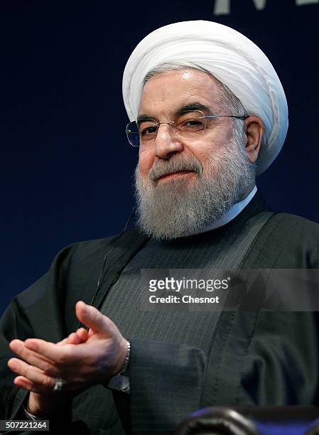 Iranian President Hassan Rouhani attends a meeting with the French Prime Minister Manuel Valls at the French employers association MEDEF headquarters...